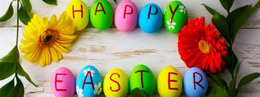 Happy-Easter-written-on-many-colored-eggs-on-a-wood-nature-table-top-counter_b Happy Easter